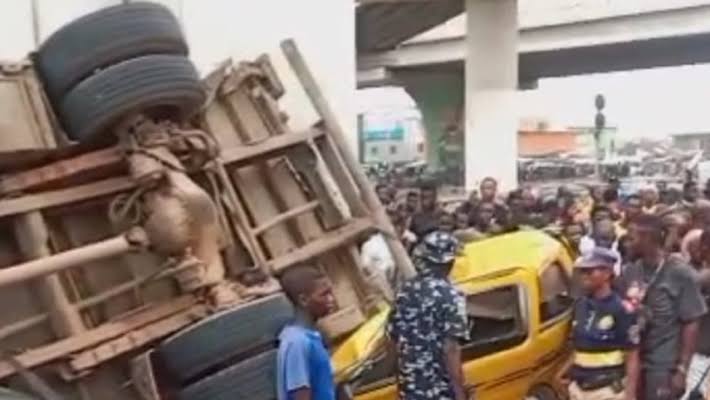Truck falls off Pen Cinema flyover, crushes two mini-buses in Lagos